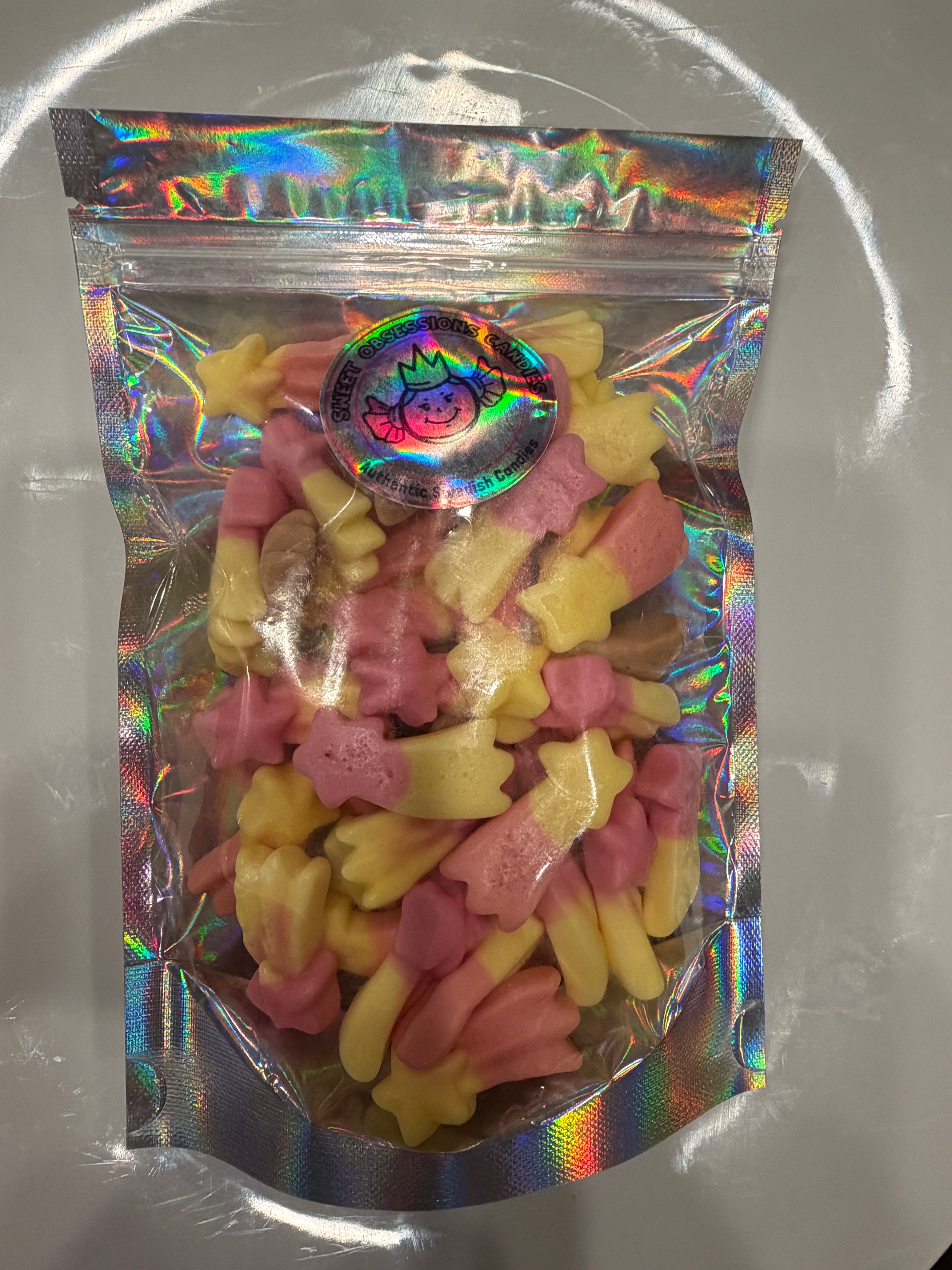 Resealable bag of Sweet Obsessions Squashies Shooting Stars gummy candies in pink and yellow star shapes