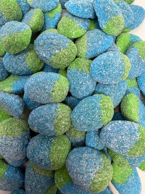 A close-up pile of sugar-coated gummy candies in blue and green two-tone colors with a sparkly sugar coating.